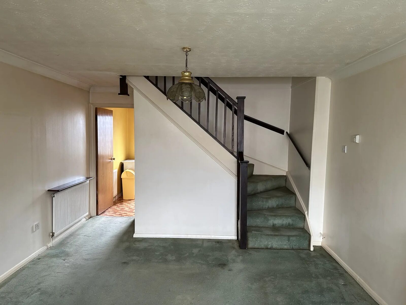 Before renovation view of the staircase and living area