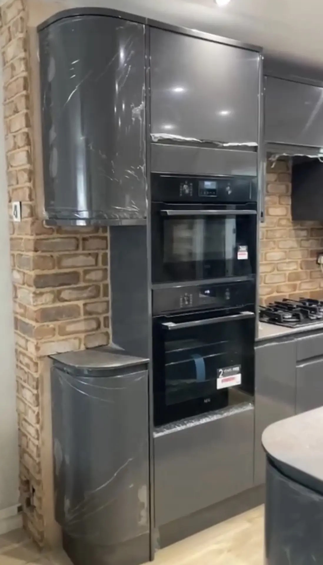 Recently completed kitchen installation with tall grey cabinetry